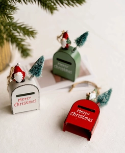Miniature metal Christmas mailboxes in red, white, and green with pine and rope detail