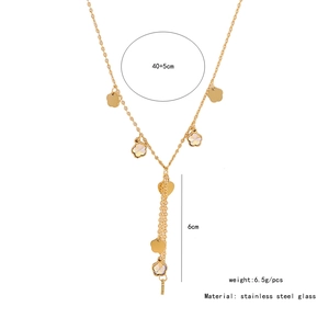 Detail of gold flower Y-necklace with crystal heart pendant and 6cm fringe drop