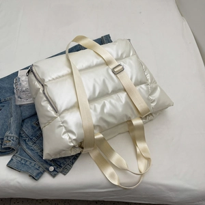 Detail of white quilted gym bag with glossy water-resistant fabric and spacious interior
