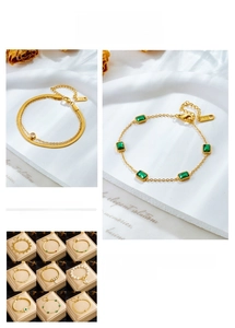 Close-up of gold titanium chain bracelets with emerald gemstones and K18 hallmark detail
