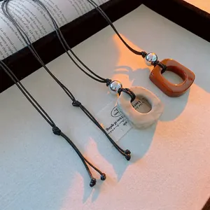 Retro geometric hollow resin pendant necklace with black cord for women's fashion