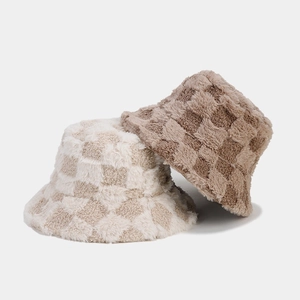 Detail of plush checkerboard bucket hats showing thick faux fur texture and warm fabric
