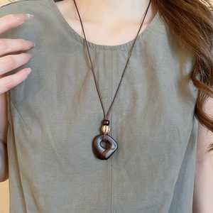 Vintage wooden hollow ring pendant on long cord necklace with tassel detail