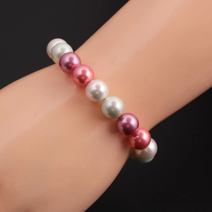 Detail of four-color shell pearl beaded bracelet on model arm for elegant fashion style