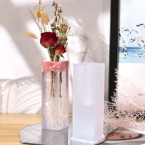 Macro detail of rectangular silicone mold with DIY floral resin flower vase creation
