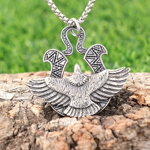 Vintage eagle pendant necklace in antique silver finish on natural wood background