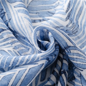 Close-up of blue banana leaf pattern fabric with breathable linen texture and fringe