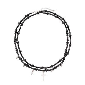 Double-layered black beaded necklace with silver cross and spike charms on white background