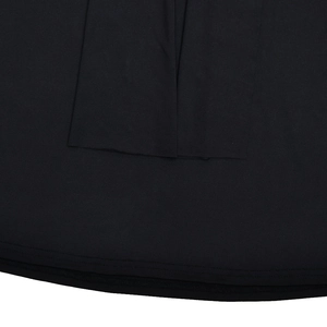 Detailed close-up showing the double-stitched hem and knitted texture of the black dress