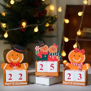 Three wooden gingerbread man Christmas countdown calendars with numbered cubes in a festive setting