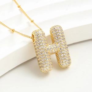 Collana dorata con ciondolo a lettera H stile palloncino e pietre di zircone
