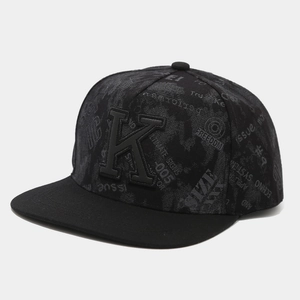 Detail of 3D embroidered K on black hip hop cap with street graffiti patterns