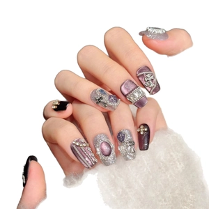Handmade press-on nails featuring rose diamond crosses, purple cat-eye and goth 3D art