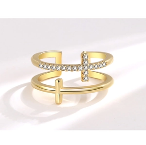 Macro shot of double-layer gold cross ring featuring sparkling cubic zirconia pave setting