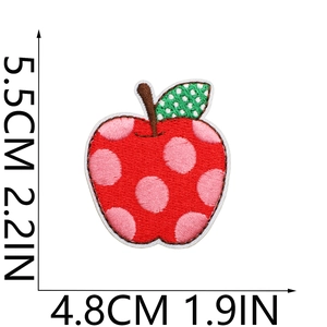Detailed size view of red apple embroidery patch with pink polka dots and green leaf