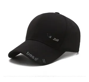 Close-up of black cotton baseball cap with white baseball text and silver sport metal tag