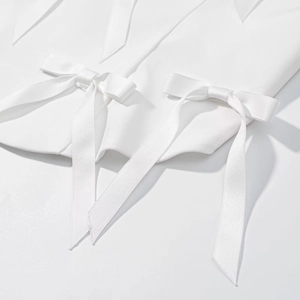 Haut dos nu élégant avec nœud en satin blanc pour un look sophistiqué et chic