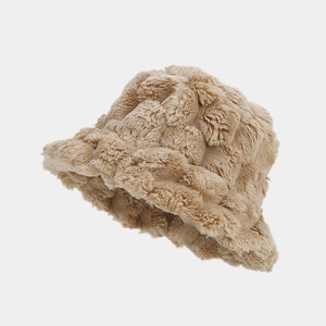 Macro detail of beige faux rabbit fur bucket hat with textured pineapple grid pattern
