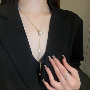 Elegant gold choker necklace with a minimalist pearl pendant on a delicate Y-shaped chain