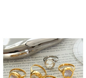 Macro detail of vintage gold and silver rings with irregular mother of pearl inlays