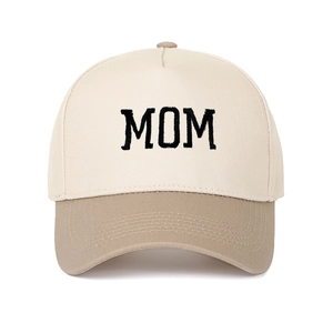 Detailed view of embroidery on MOM lettered two-tone cream and brown trucker hat