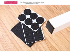 Detail view of anti-slip EVA pads for furniture legs on wood floor with self-adhesive backing