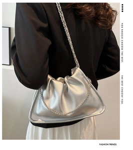 Detailed view of silver cloud bag featuring soft lychee grain texture and chain strap