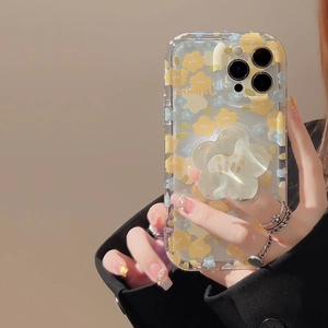 Close-up of clear phone case with floral patterns and a 3D flower shape stand accessory