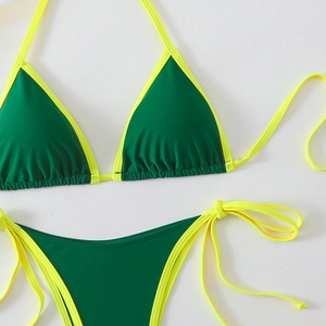 Detail of cross-strap bikini set with contrast neon yellow trim and dark green fabric