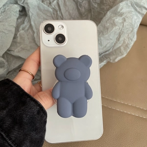 Detail of matte fog blue 3D bear phone grip holder being held on a smartphone