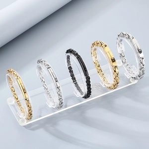 Macro view of five stainless steel Byzantine chains in gold, silver and black finishes