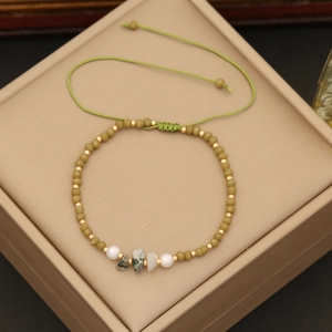 Bohemian handmade beaded bracelet with green natural stones on jewelry display box