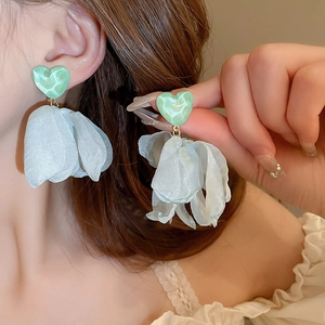 Detail of mint green resin heart stud with light blue chiffon flower petals earring