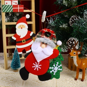 Detail of plush Santa Claus hugging a green Christmas tree ornament for holiday decor