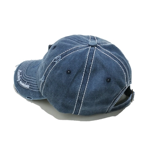 Macro detail of distressed vintage denim baseball cap with Lucky Numbers embroidery