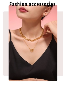 Detail of layered gold-plated heart pendant necklace with zircon inlay on a female model