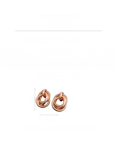 Detail view of intertwined rose gold oval earrings with textured and smooth finishes