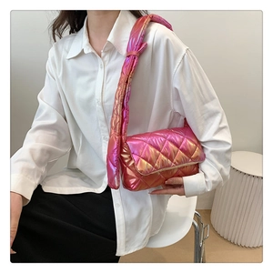 Detail of gradient pink quilted shoulder bag showing padded texture and glossy finish