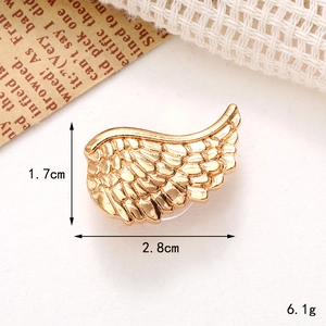 Detailed view of gold wing shoe charm with dimensions 2.8cm x 1.7cm and feather texture