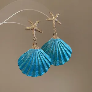 Golden starfish and blue shell drop earrings for ocean themed summer beach jewelry