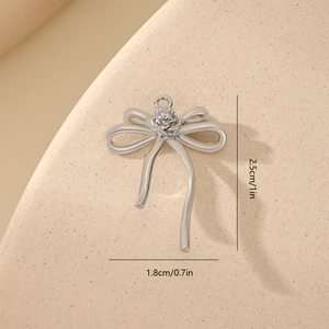 Silver bow pendant with cubic zirconia inlay showing dimensions 2.5cm by 1.8cm