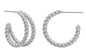 Detailed close-up of silver twist texture hoop earrings with polished metallic finish