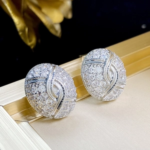 Macro detail of silver oval earrings with sparkling cubic zirconia pavé and S-curve design