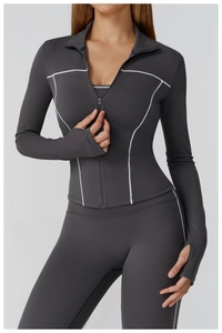 Detail of slim fit yoga jacket with contrast stitching and thumbholes on the sleeves