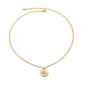 Macro detail of gold stainless steel necklace with evil eye pendant and zircon inlay