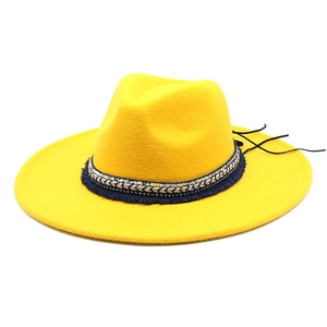 Detail of yellow wool felt fedora featuring blue tassels and rhinestone hatband decoration