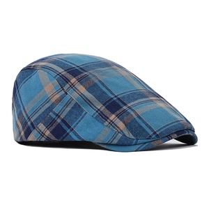 Side view of a vintage plaid flat cap featuring blue and tan woven cotton texture