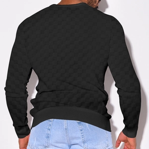 Detail showing the heavy jacquard checkerboard texture on men's black knit sweater back