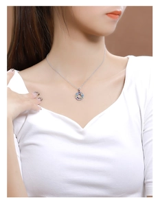 Close-up of a 925 silver rainbow pendant necklace worn by a female model on neck