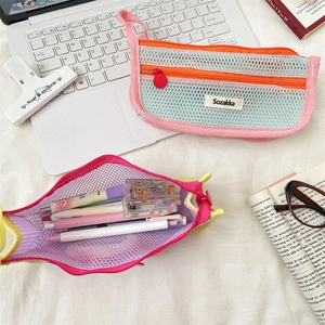 Detailed top view of large capacity mesh pencil case with colorful stationery on desk